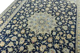 Backside of handmade 2000s Kashan rug showing knot structure and weave density