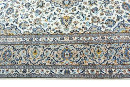 Corner detail of 2000s Kashan rug showing border pattern and Wool pile