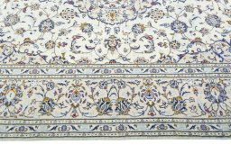 Corner detail of 2000s Kashan rug showing border pattern and Wool pile