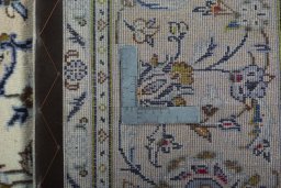 Backside of handmade 2000s Kashan rug showing knot structure and weave density