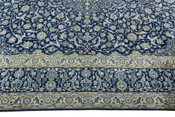 Corner detail of 2000s Kashan rug showing border pattern and Wool pile