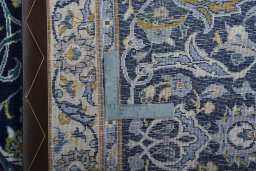 Backside of handmade 2000s Kashan rug showing knot structure and weave density