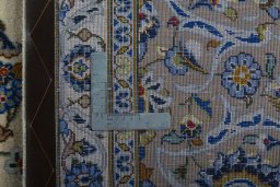 Backside of handmade 2000s Kashan rug showing knot structure and weave density