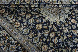 Close-up detail of 2000s Kashan rug from Iran / Persia showing Wool weave