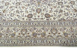 Corner detail of 2000s Kashan rug showing border pattern and Wool pile