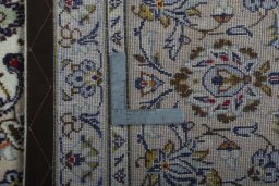 Backside of handmade 2000s Kashan rug showing knot structure and weave density