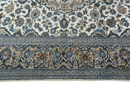 Corner detail of 2000s Kashan rug showing border pattern and Wool pile