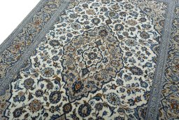 Backside of handmade 2000s Kashan rug showing knot structure and weave density