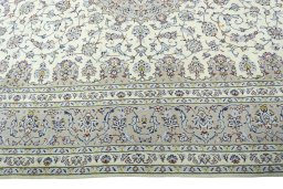 Corner detail of 2000s Kashan rug showing border pattern and Wool pile