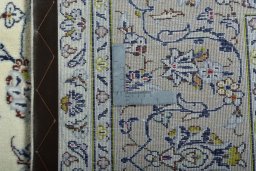 Backside of handmade 2000s Kashan rug showing knot structure and weave density