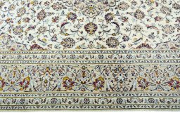 Corner detail of 2000s Kashan rug showing border pattern and Wool pile