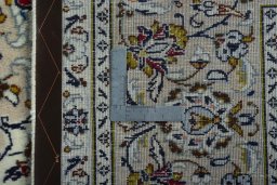 Backside of handmade 2000s Kashan rug showing knot structure and weave density