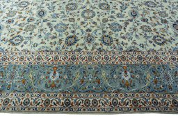 Corner detail of 2000s Kashan rug showing border pattern and Wool pile