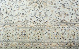 Corner detail of 2000s Kashan rug showing border pattern and Wool pile