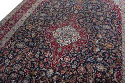 Backside of handmade 2000s Kashan rug showing knot structure and weave density