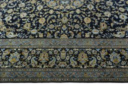 Corner detail of 2000s Kashan rug showing border pattern and Wool pile