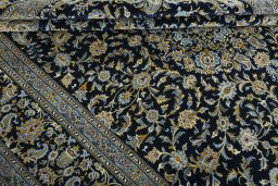 Close-up detail of 2000s Kashan rug from Iran / Persia showing Wool weave