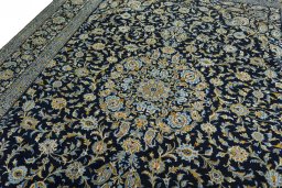 Backside of handmade 2000s Kashan rug showing knot structure and weave density