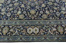 Corner detail of 2000s Kashan rug showing border pattern and Wool pile