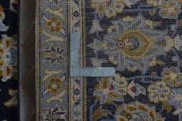 Backside of handmade 1970s Kashan rug showing knot structure and weave density