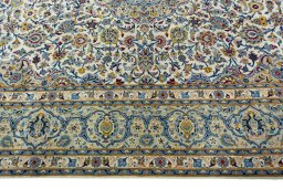 Corner detail of 2000s Kashan rug showing border pattern and Wool pile