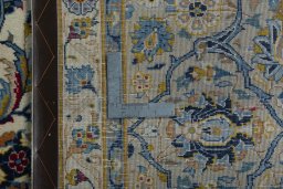 Backside of handmade 2000s Kashan rug showing knot structure and weave density