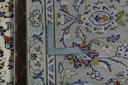 Backside of handmade 2000s Kashan rug showing knot structure and weave density