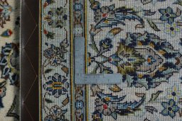 Backside of handmade 2000s Kashan rug showing knot structure and weave density