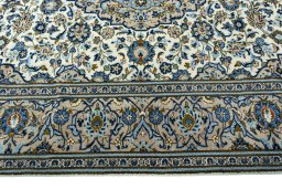 Corner detail of 2000s Kashan rug showing border pattern and Wool pile