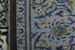 Backside of handmade 2000s Kashan rug showing knot structure and weave density
