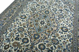 Backside of handmade 2000s Kashan rug showing knot structure and weave density
