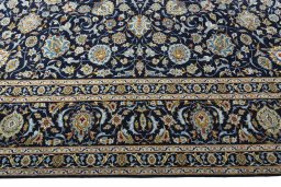 Corner detail of 2000s Kashan rug showing border pattern and Wool pile