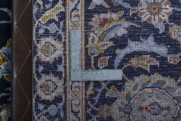 Backside of handmade 2000s Kashan rug showing knot structure and weave density