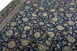 Backside of handmade 2000s Kashan rug showing knot structure and weave density