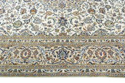 Corner detail of 2000s Kashan rug showing border pattern and Wool pile