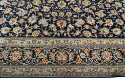Corner detail of 2000s Kashan rug showing border pattern and Wool pile