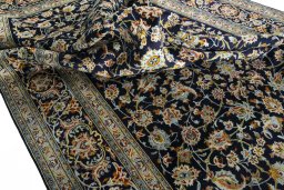 Surface texture of 2000s Kashan rug with natural Wool and intricate pattern