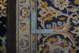 Backside of handmade 2000s Kashan rug showing knot structure and weave density