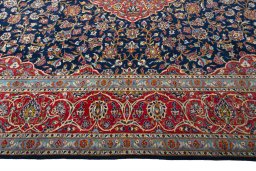 Corner detail of 2000s Kashan rug showing border pattern and Cork pile