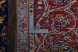 Backside of handmade 2000s Kashan rug showing knot structure and weave density