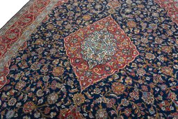 Backside of handmade 2000s Kashan rug showing knot structure and weave density