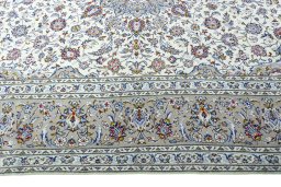 Corner detail of 2000s Kashan rug showing border pattern and Wool pile