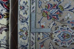 Backside of handmade 2000s Kashan rug showing knot structure and weave density