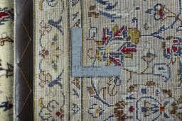Backside of handmade 2000s Kashan rug showing knot structure and weave density