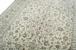 Backside of handmade 2000s Kashan rug showing knot structure and weave density