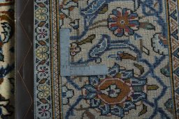 Backside of handmade 2000s Kashan rug showing knot structure and weave density
