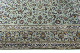 Corner detail of 2000s Kashan rug showing border pattern and Wool pile