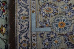 Backside of handmade 2000s Kashan rug showing knot structure and weave density