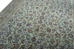 Backside of handmade 2000s Kashan rug showing knot structure and weave density