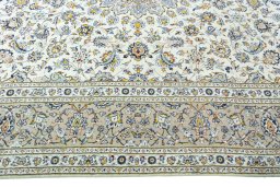 Corner detail of 2000s Kashan rug showing border pattern and Wool pile